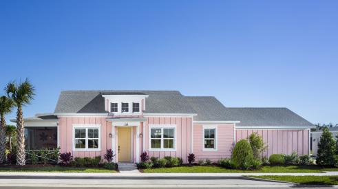 Pink exterior of Conch Collection Cottage (Alloha model) by Minto Communities