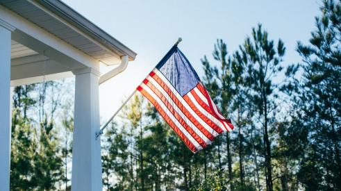 American flag on porch outside of house