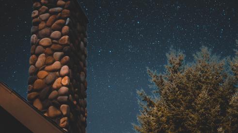 Chimney under night sky with stars