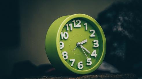 Green clock on table