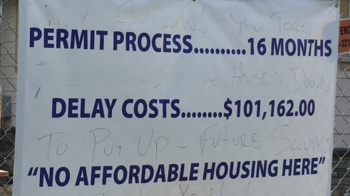 Banner about no affordable housing because costs are up due to regulations