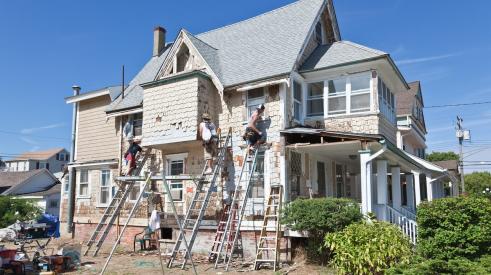People remodeling exterior of beach house