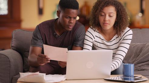 Black couple looking at homes online