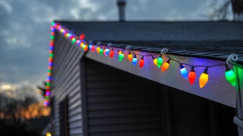 Single-family home with Christmas lights on roof