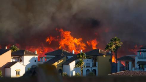 Homes next to hillside on fire in California