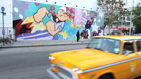 Checker cab in NYC in front of mural