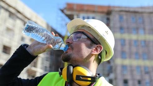 Construction worker drinking water