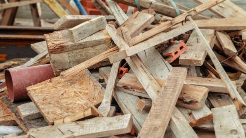 Plywood, lumber, and other construction waste in a pile on the jobsite
