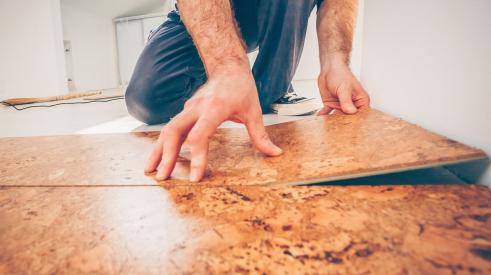 Builder/remodeler installing cork flooring in home