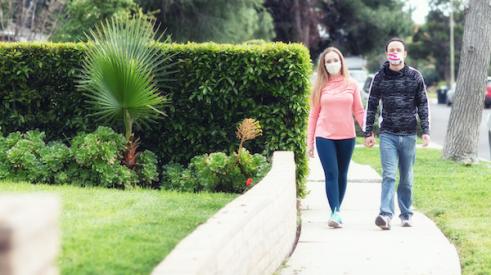 Couple walking in suburbs