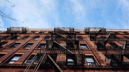 Building exterior | Multifamily real estate had one of its best since 2000: multifamily debt hit an all-time high, renters paid more for housing than ever, and deliquencies remained at historic lows.