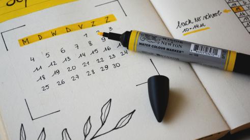 September calendar with highlighter on table