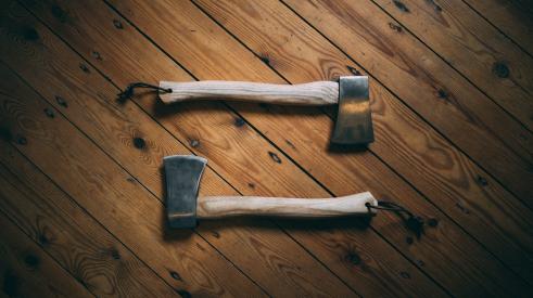 Two axes on wooden board