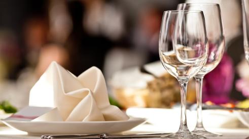 White napkins and wine glasses on table