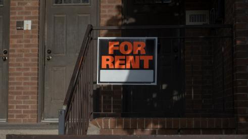 Orange and black for rent sign outside of house