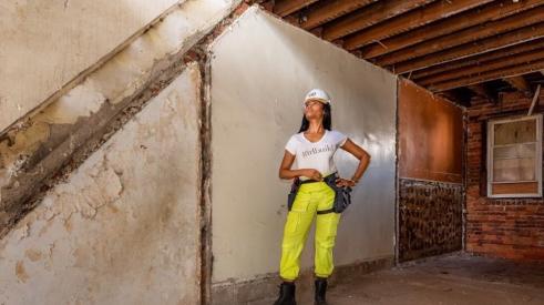 Monica Miraglilo of GirlBuild Lab standing in a building being renovated