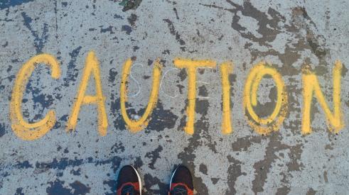 'Caution' written in yellow spray paint