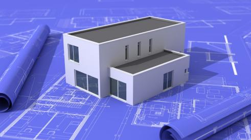 Modern white house model on construction blueprints