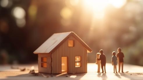 Small wooden house model with figurines outside