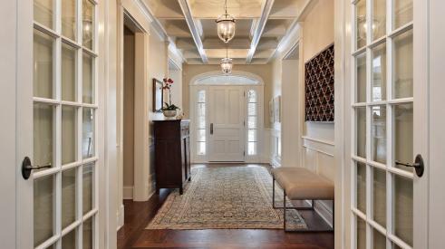 House foyer with glass french doors and bright accents 