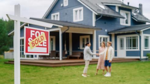 Sold sign in lawn outside of residential home