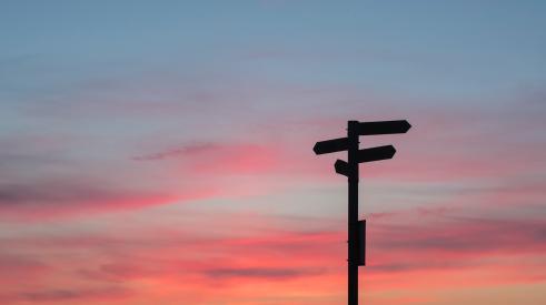 Signposts shadowed at sunset