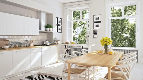 White kitchen with black and white rug accent and large windows