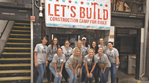 Girls at the Let's Build Construction Camp learning plumbing skills