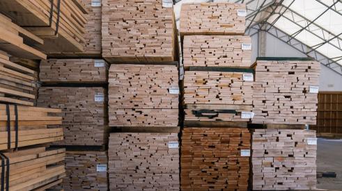 Lumber pallets marked and stacked in warehouse