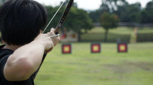Man fires arrow at target