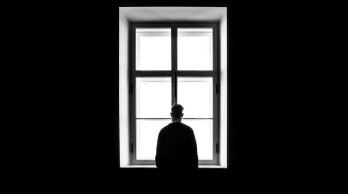 man facing window