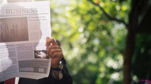 Man reading business newspaper