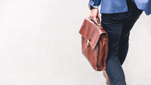 Businessman with briefcase walking