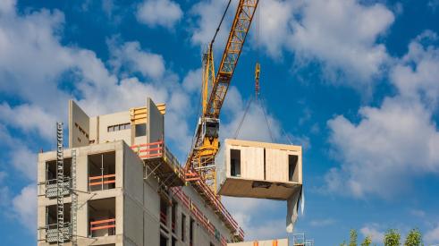 Modular units being installed by crane on a multifamily project 