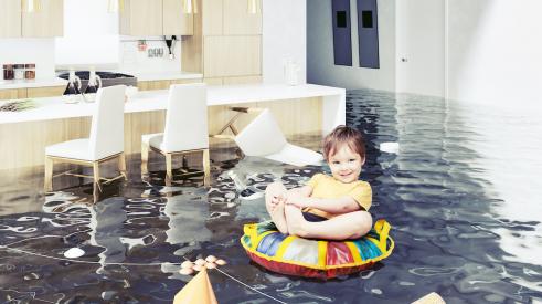 Baby on floaty in a flooded living room