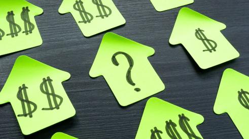 Green house cutouts with dollar signs surround a cutout with a question mark on it