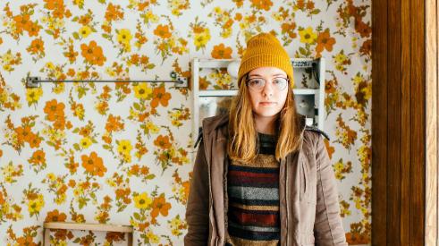 Woman standing in bathroom with '70s décor