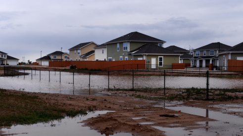 Standing water around new homes after heavy rain