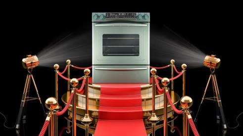 Silver stove range on pedestal in spotlight on red carpet 