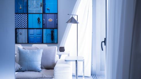 House interior with lamp sofa and blue wall hanging