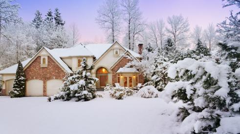 Winter home in the evening with outdoor lighting