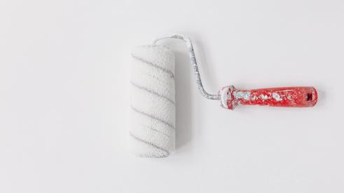 Paint roller against a white wall