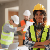 Young woman on construction site wearing yellow hardhat