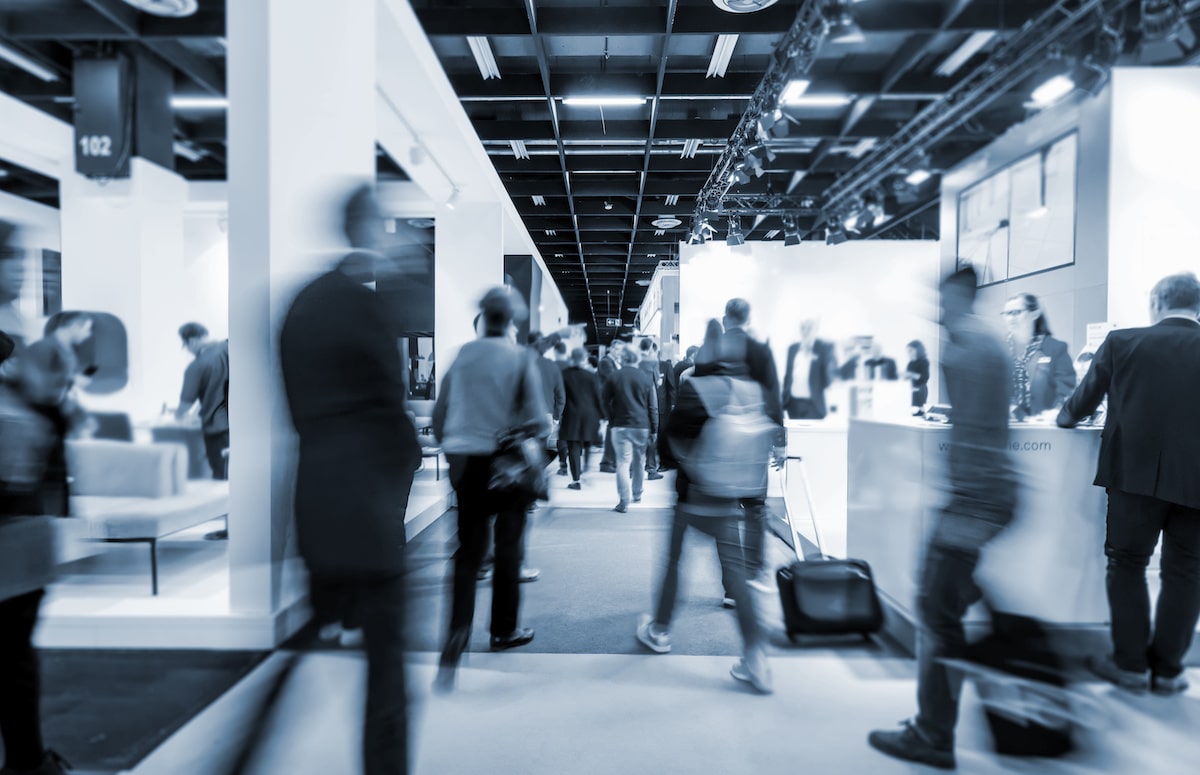 Blurred black and white image of people at construction trade show