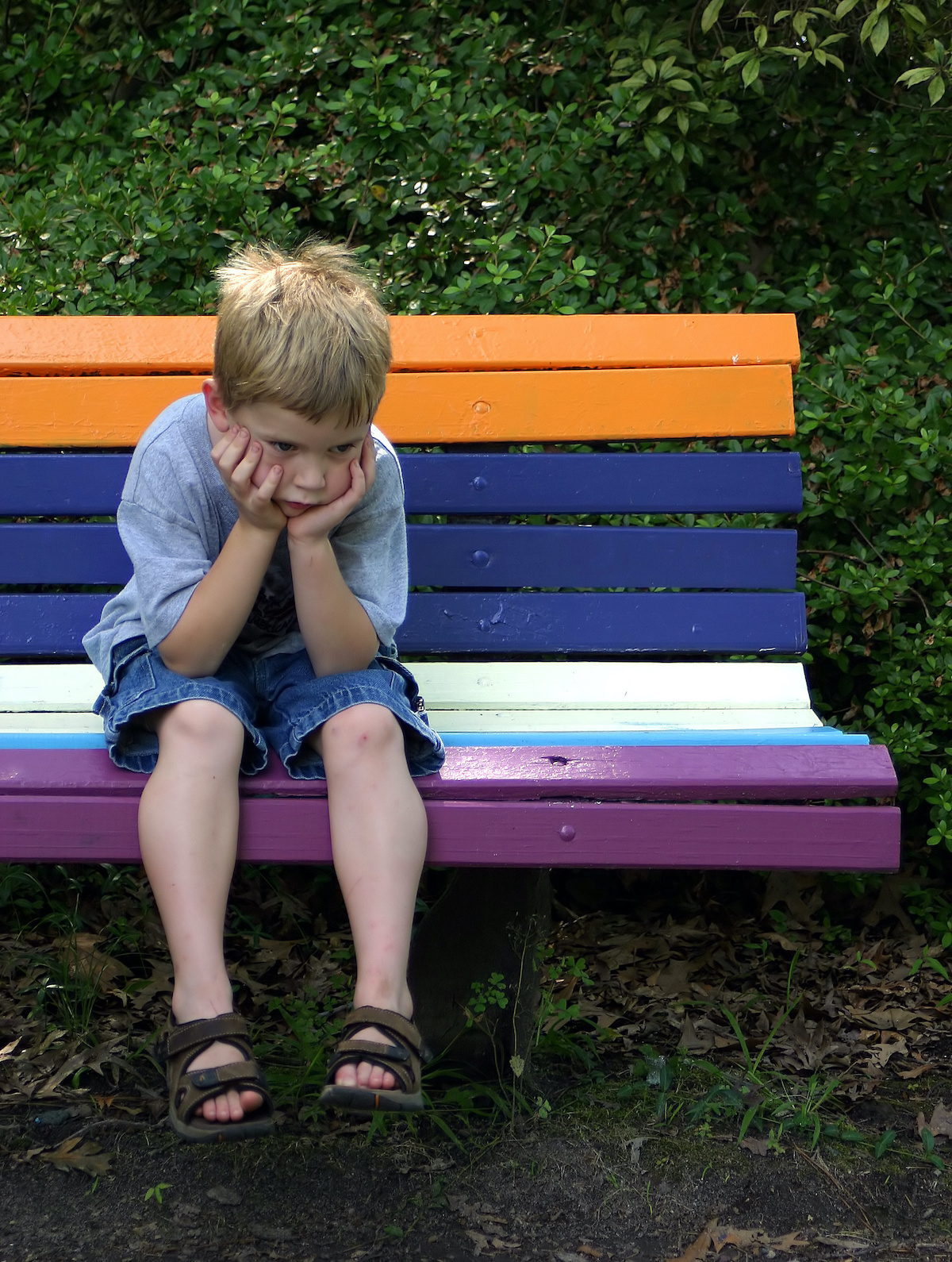 Boy on bench pouting