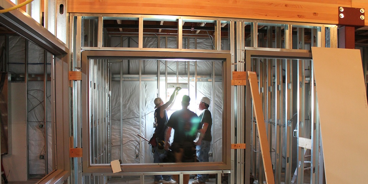 Framers installing a window