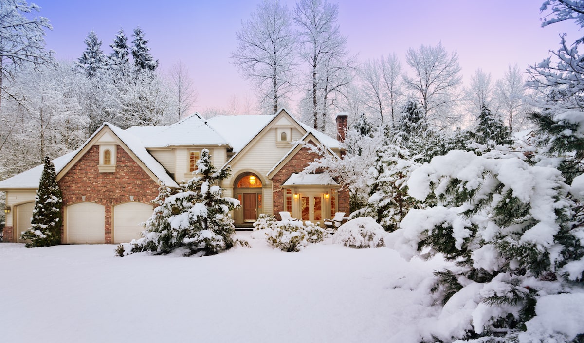 Winter home in the evening with outdoor lighting