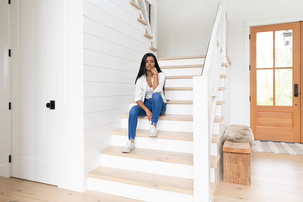 Woman sitting on the stairs in suburban home