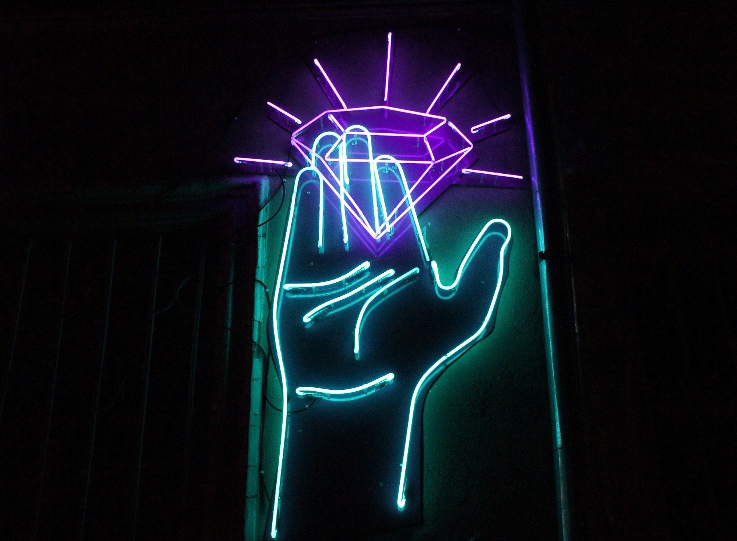 Neon sign of hand and diamond