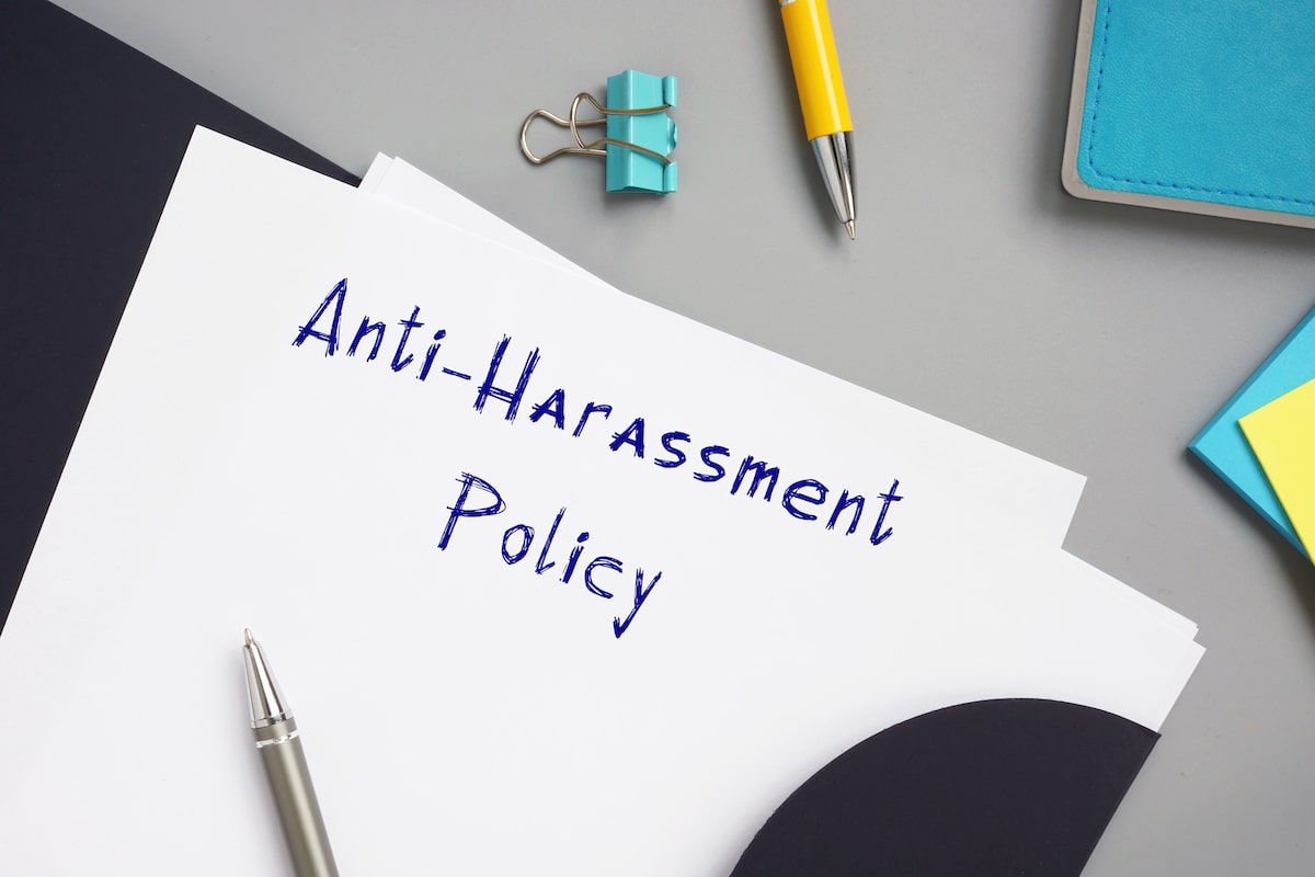 A piece of paper reads, "Anti-Harassment Policy."